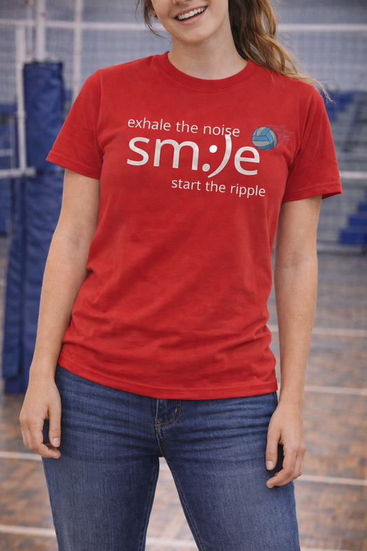 Person wearing a red t-shirt with motivational text in an indoor setting